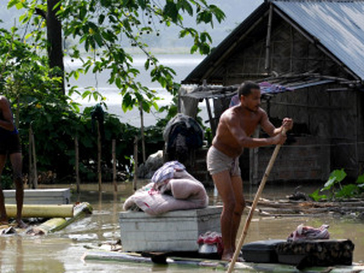 A villager moves his belongings on a ban
